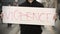 Activist holds a placard with handwritten text