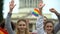 Activists chanting LGBT slogans, showing painted rainbow symbols on hands, flags