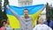 Activists raising Ukrainian flag chanting slogan, independence rally, patriotism