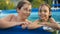 Activities on the pool. Cute kids - sister and brother swimming and playing in water in swimming pool in aquapark