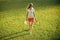 Activity, energy, health. Girl athlete in uniform with cap on green grass