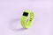 Activity smart tracker on light pink background. Green fitness health watch, sport bracelet