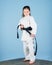 Activity and sport. Karate gives feeling of confidence. Strong and confident kid. Girl little child in white kimono with