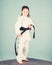 Activity and sport. Karate gives feeling of confidence. Strong and confident kid. Girl little child in white kimono with
