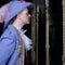 Actor dressed historical costume in interior of old theater.