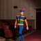 Actor dressed jester`s costume in interior of old theater.