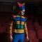 Actor dressed jester`s costume in interior of old theater.