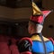 Actor dressed jester`s costume in interior of old theater.