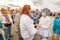 actor of the St. Petersburg Theater Non Stop Theater after a street performance hugs a fan on the waterfront at the festival `Vo