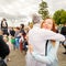 actor of the St. Petersburg Theater Non Stop Theater after a street performance hugs a fan on the waterfront at the festival `Vo