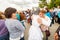 actor of the St. Petersburg Theater Non Stop Theater after a street performance hugs a fan on the waterfront at the festival `Vo