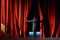 Actor in a tuxedo stage curtain opens