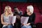 Actors reading their scripts on stage in theatre