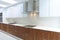 Actual modern kitchen in white and walnut wood