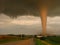 Actual photograph of a tornado at sunset narrowly missing a farm in rural Iowa.