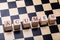 Acumen Word On Wooden Block Over Chessboard