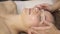 Acupressure on a female face. masseur makes Chinese alternative massage