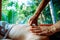 Acupressure massage in spa centre outdoor. Woman at acupressure back massage, masseur`s hands close up. Body therapy for healthy