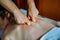 Acupressure massage in spa centre. Woman at acupressure back massage, masseur`s hands close up. Body therapy for healthy life