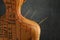 Acupuncture - alternative medicine. Human model with needles in shoulder near dark grey background, back view