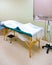 Acupuncture, Massage Table & Heat Lamp In Treatment Room