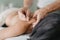 acupuncturist pinches patient& x27;s neck to insert acupuncture needle