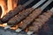 Adana kebab ground lamb minced meat on skewer on grill over charcoal