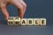 Adaptable or variable symbol. Businessman turns wooden cubes and changes the word variable to adaptable. Beautiful grey background