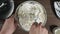 Add ingredients to a glass bowl. Male hands making dessert. Delicious soft sour cream cheese sweet cream. Kneading the ingredients