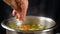 Add a salt to vegetable soup, slow motion
