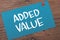 Added value  text words typography written on paper against wooden background  life and business motivational inspirational