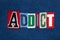 ADDICT text word collage, colorful fabric on blue denim, health and addiction concept