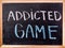 Addicted game word on blackboard