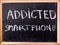 Addicted smartphone word on blackboard