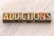 Addictions word abstract in wood type