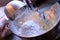 Adding 1 cup of confectioner\'s sugar to frosting mixture