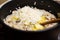 Adding butter and parmigiana in a risotto dish