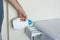 Adding detergent to dispenser of washing machine