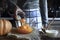 Adding eggs in the pumpkin puree in the glass bowl