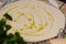 Adding extra virgin olive oil on the dough for pizza on a wooden board