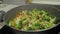 Adding flavoring to vegetables on frying pan. Carrots, cauliflower, broccoli