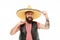 Adding hat to his spanish costume. Bearded man smiling in traditional sombrero hat. Happy hipster with beard and