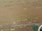 Adding herbicide tractor on the field of ripe wheat. View from above.