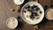 Adding ingredients in breakfast bowl with Blueberries and Amaranth