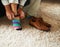 Adding a little bit of fun to the outfit. Cropped shot of a man putting on colourful socks and loafers.