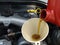 Adding Motor Oil to Car Closeup