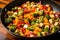 adding tofu pieces to a colorful vegetable mix in a pan