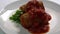 Adding tomato sauce on stuffed cabbage leaves with minced meat, rice, herbs