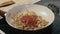 Adding tomato sauce to the Golden fried onion in the pan.