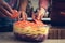 Adding tomatoes in the baking dish with raw meat and potatoes